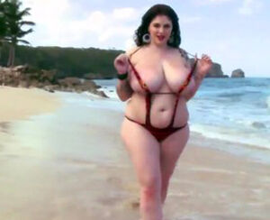 Sensuous obese girlposing on beach